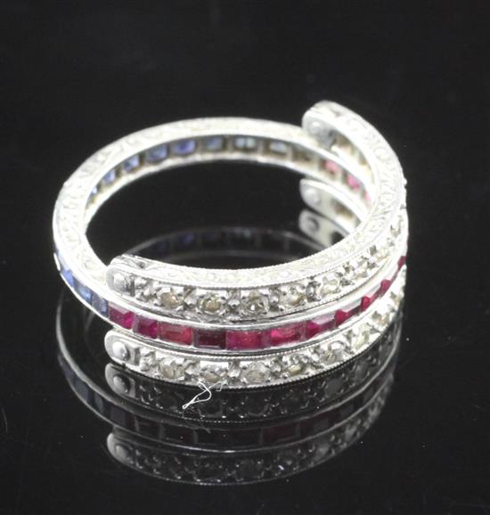 A 1920s platinum, sapphire, ruby and diamond triple eternity ring, size L.